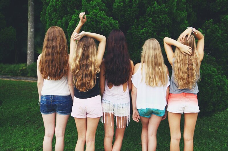 five girls from behind in a park