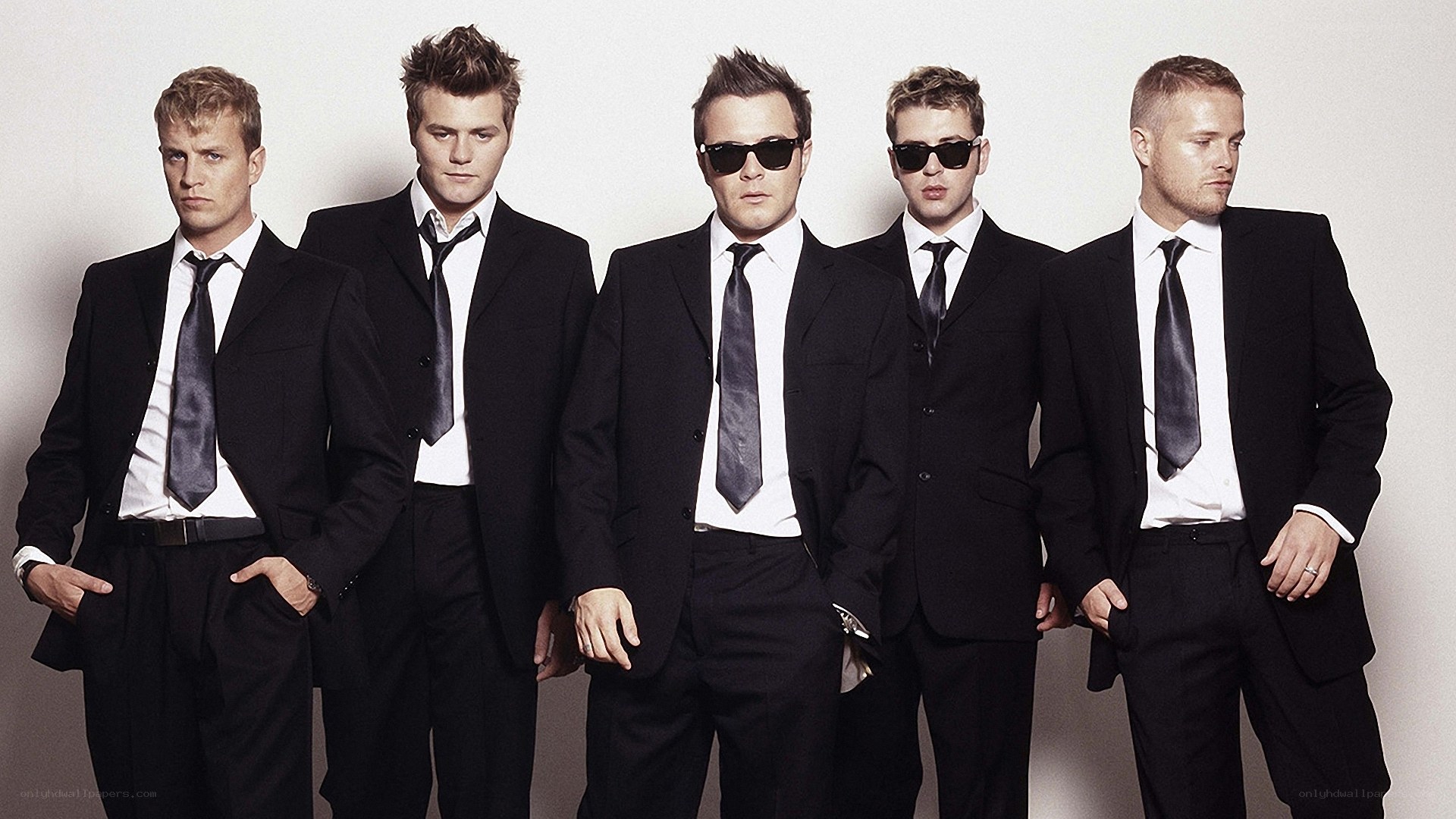five men in black suits