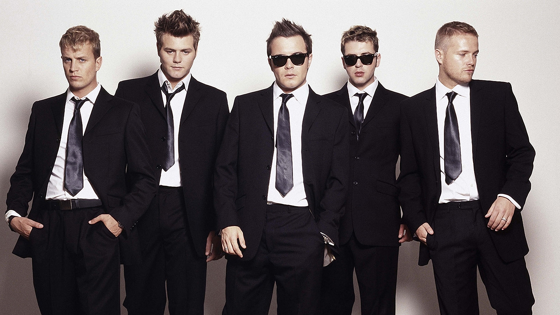 five men in black suits