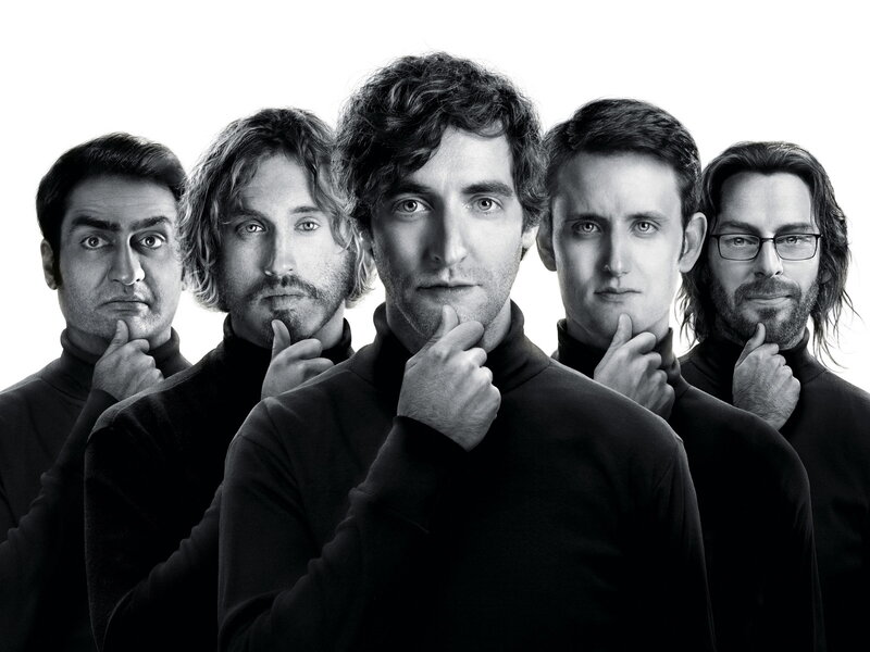 Five men in black turtlenecks