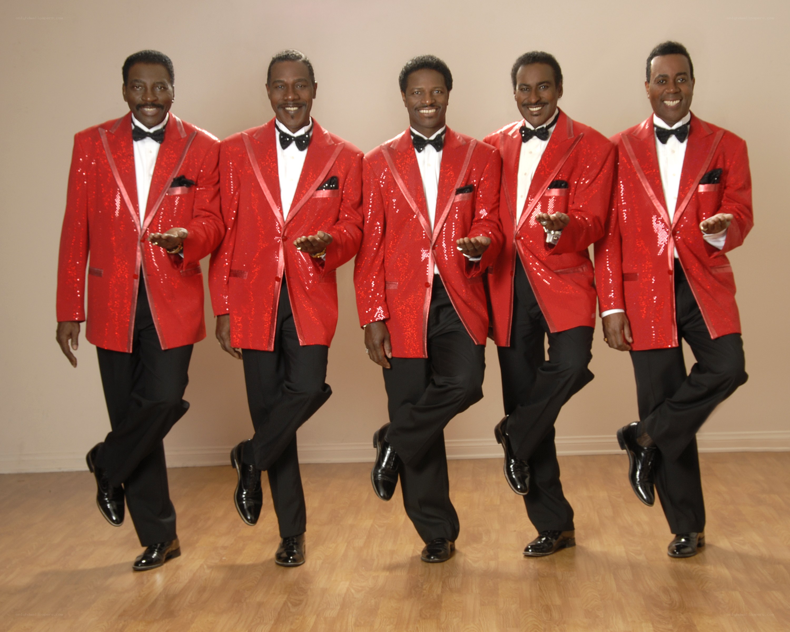five men in red sequin jackets