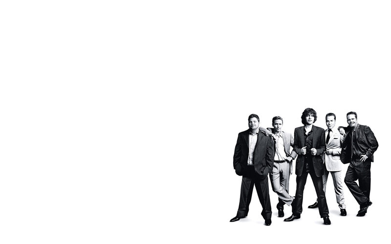 five men in suits posing