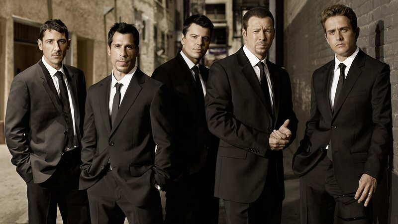 Five men in suits standing together