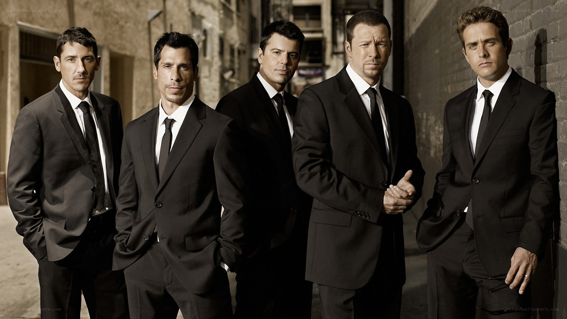 Five men in suits standing together