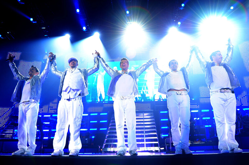 Five men on stage in white