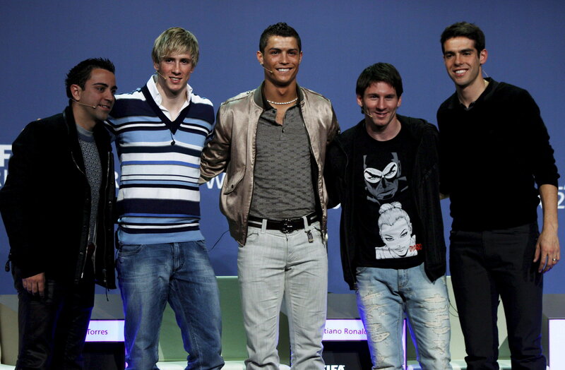 five men on stage smiling