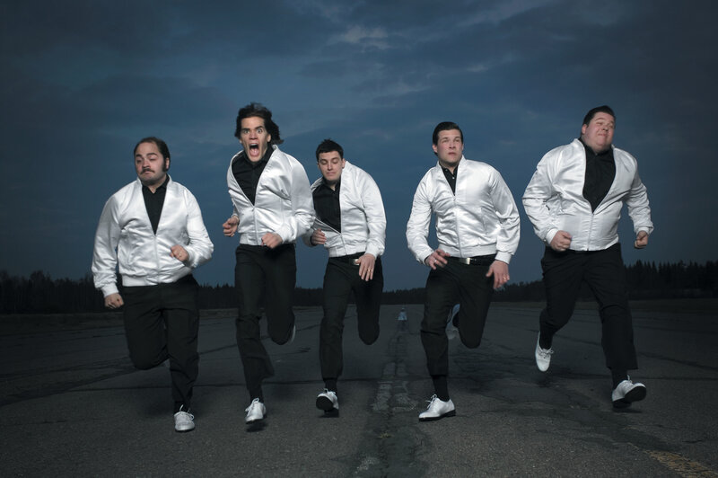 five men running on a runway