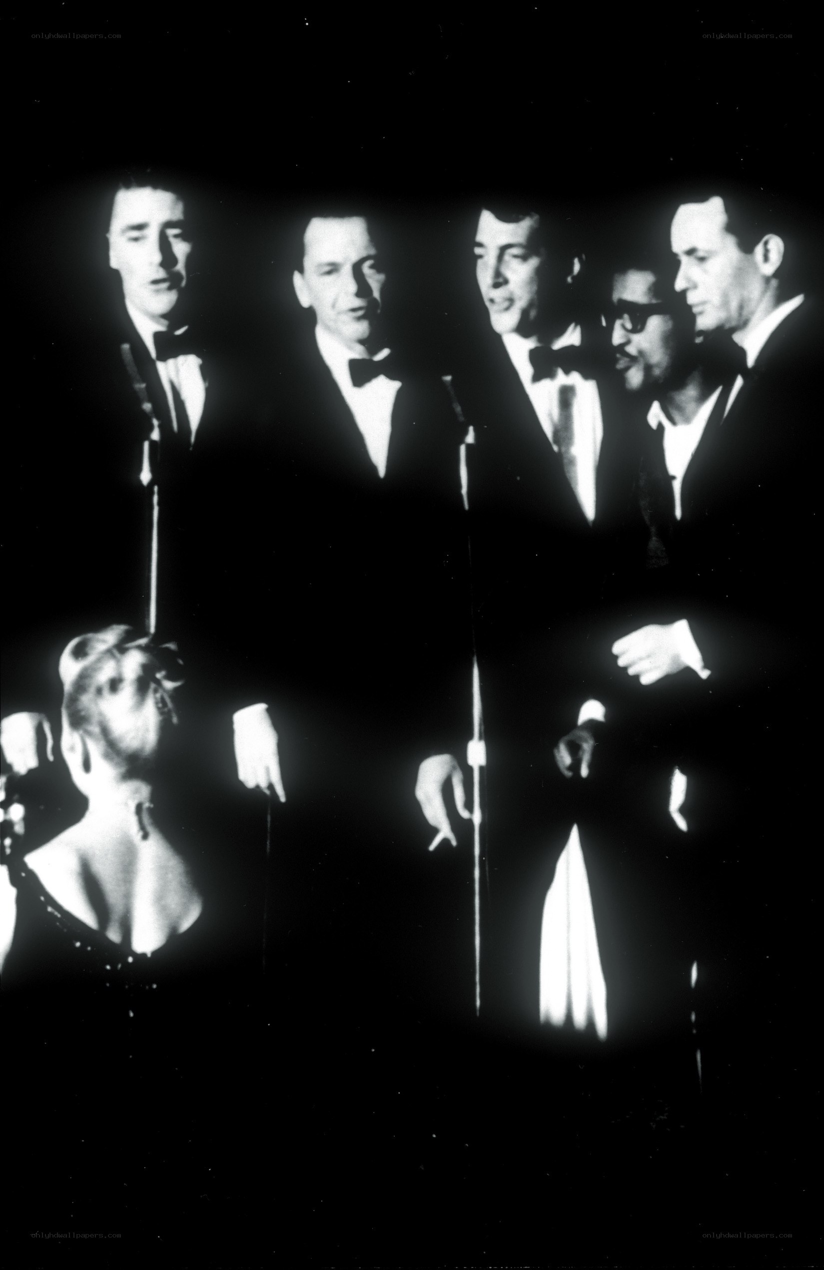 Five men singing on stage