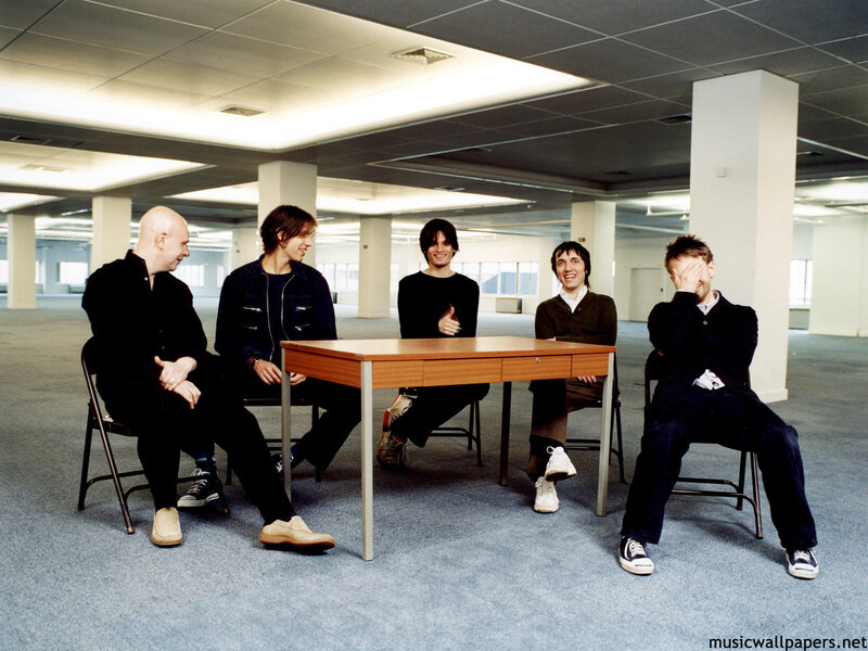 Five Men Sitting Around Table