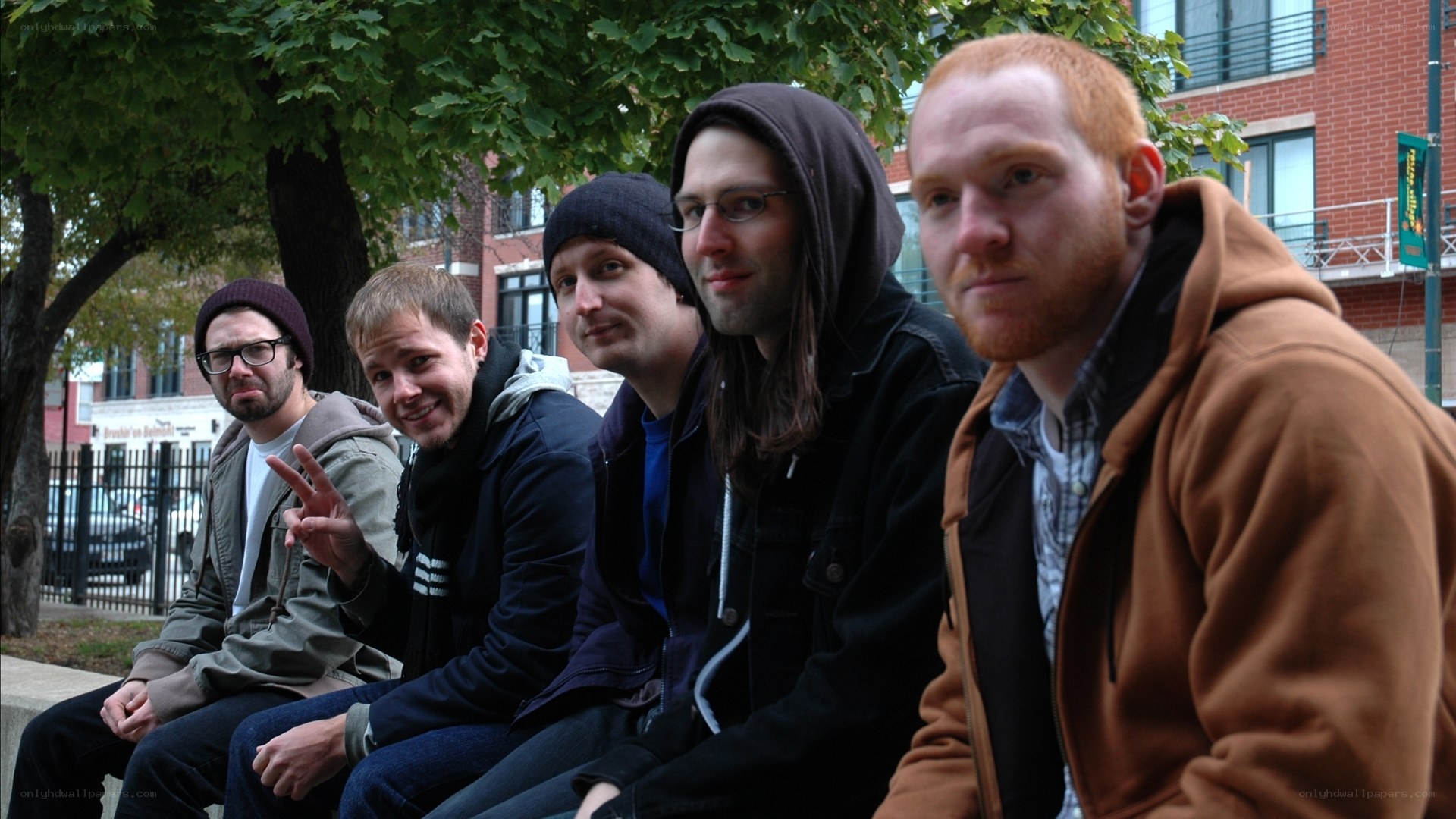 five men sitting on a bench
