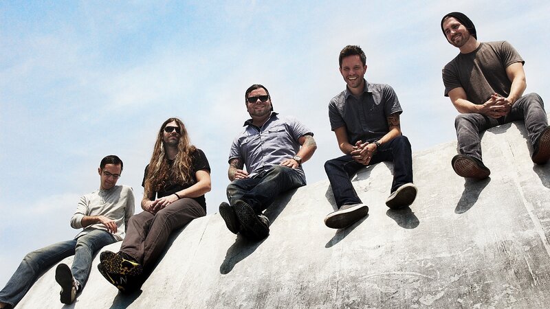 Five Men Sitting on Concrete