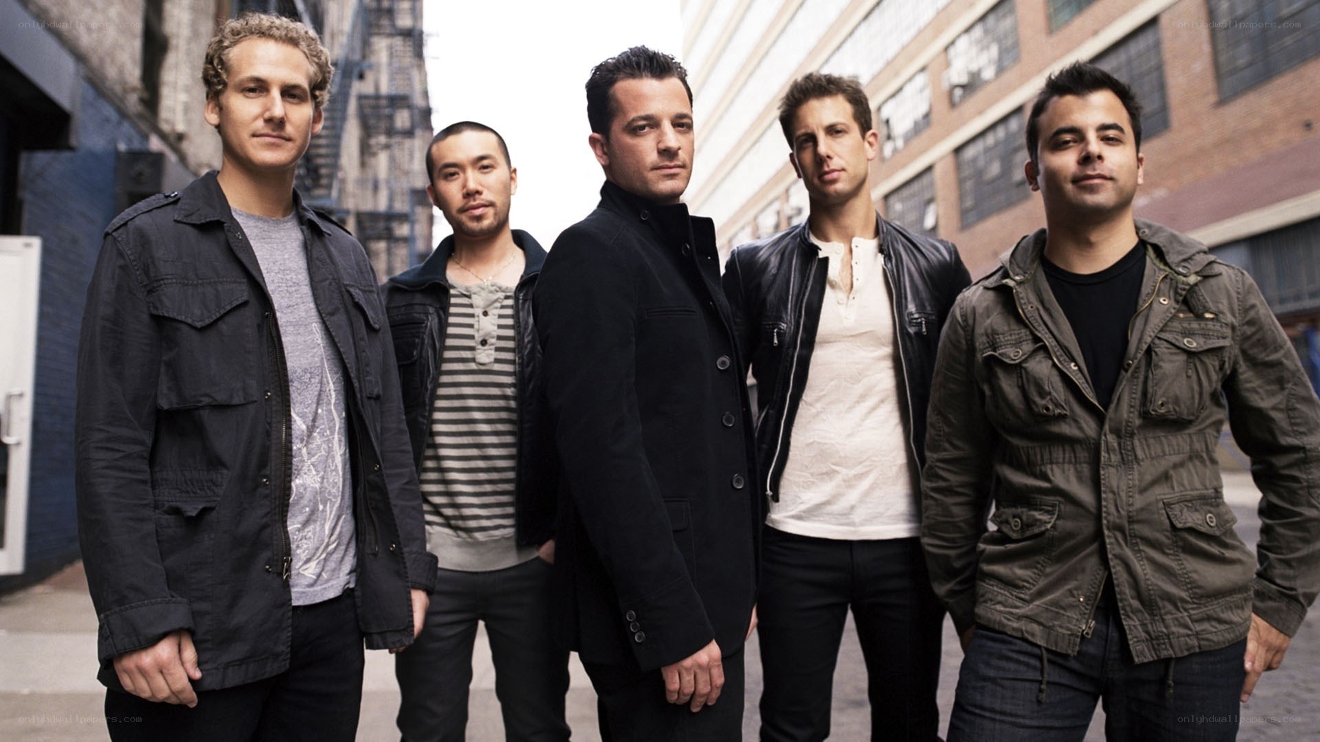 five men standing in alley
