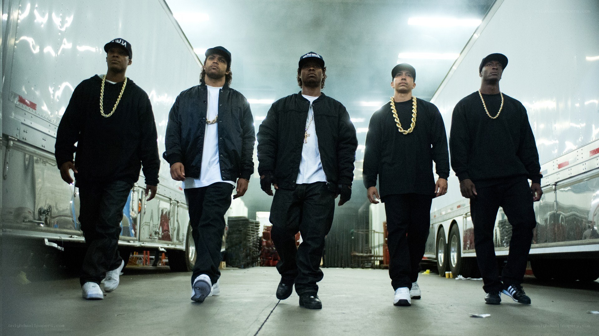 five men walking in warehouse