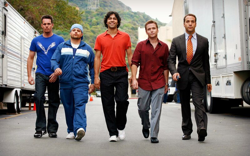 five men walking on set