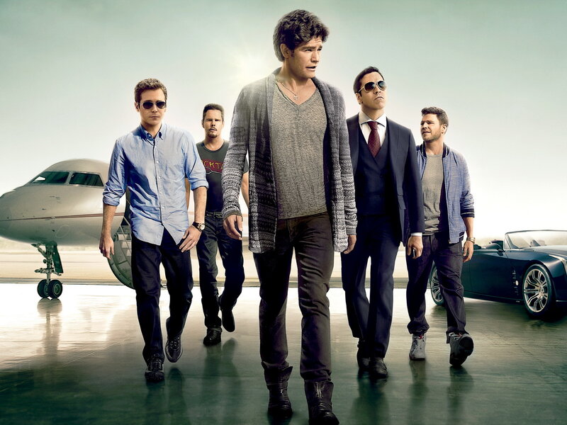five men walking on tarmac