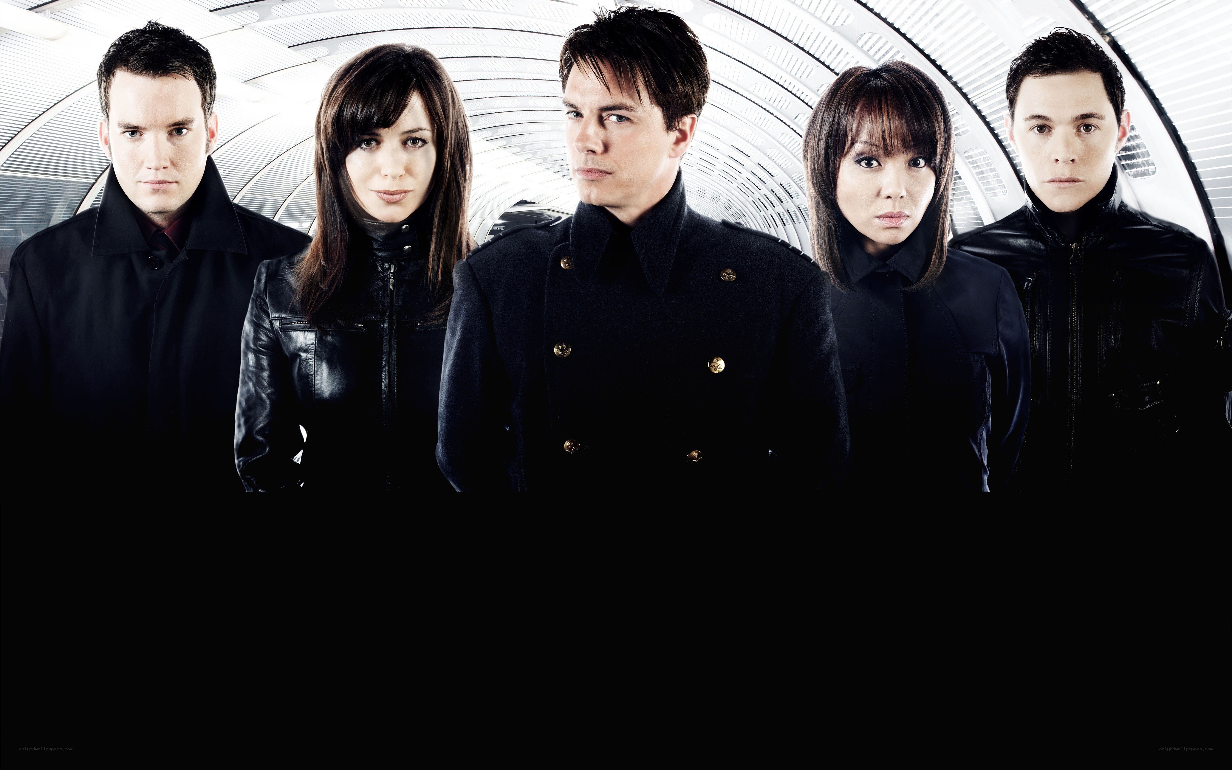 five people in black coats