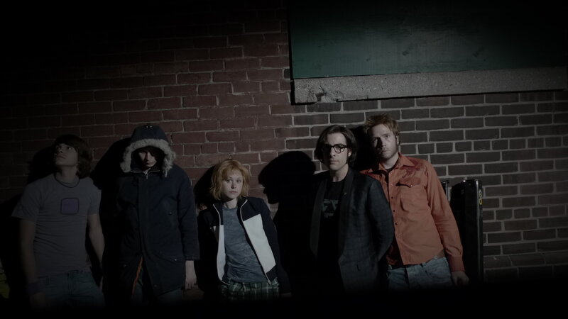 five people in dark alley