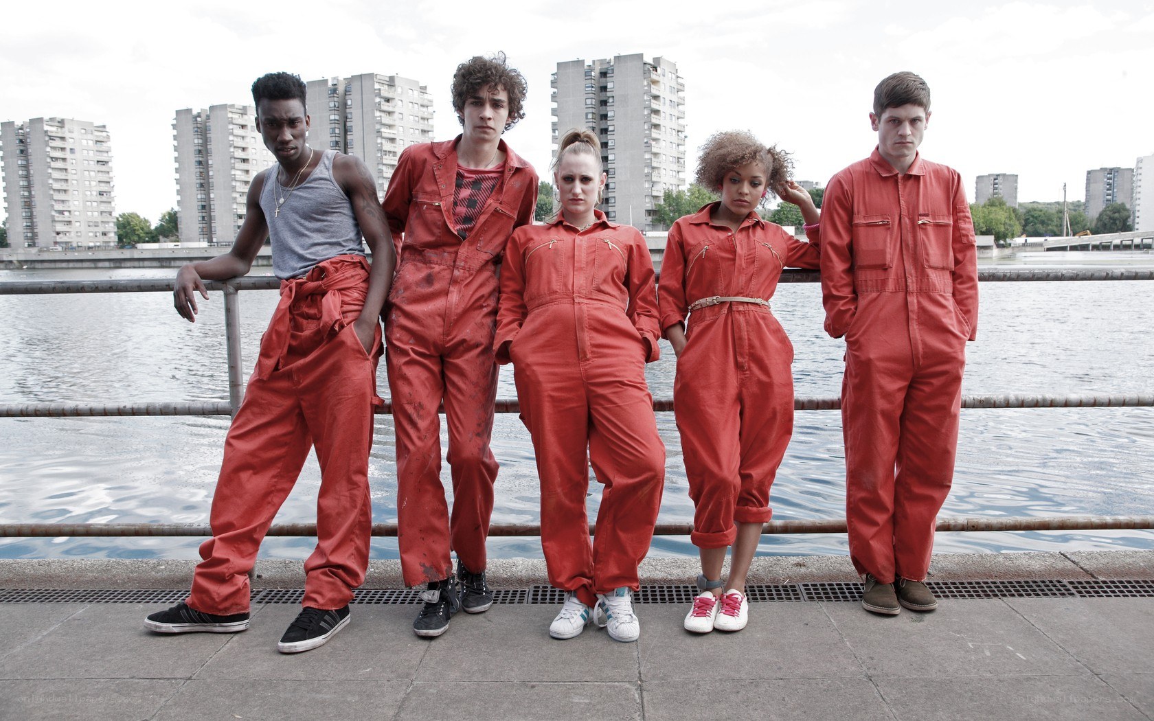 five people in red jumpsuits