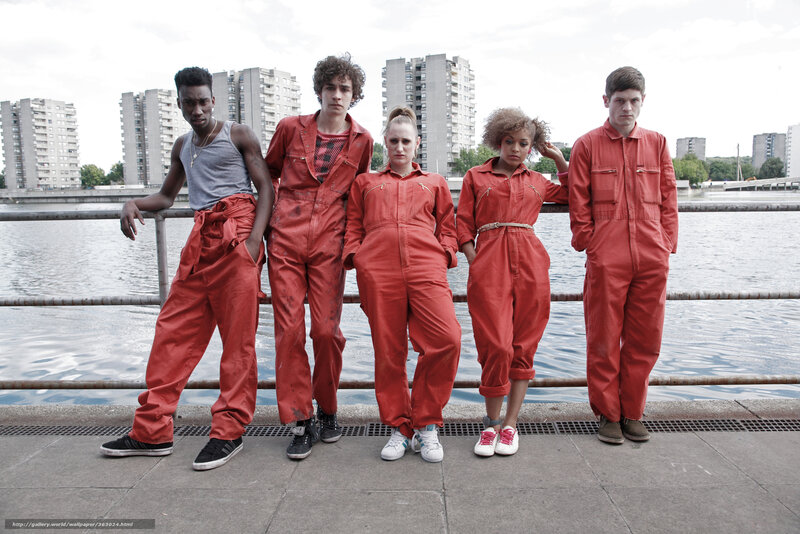 five people in red jumpsuits