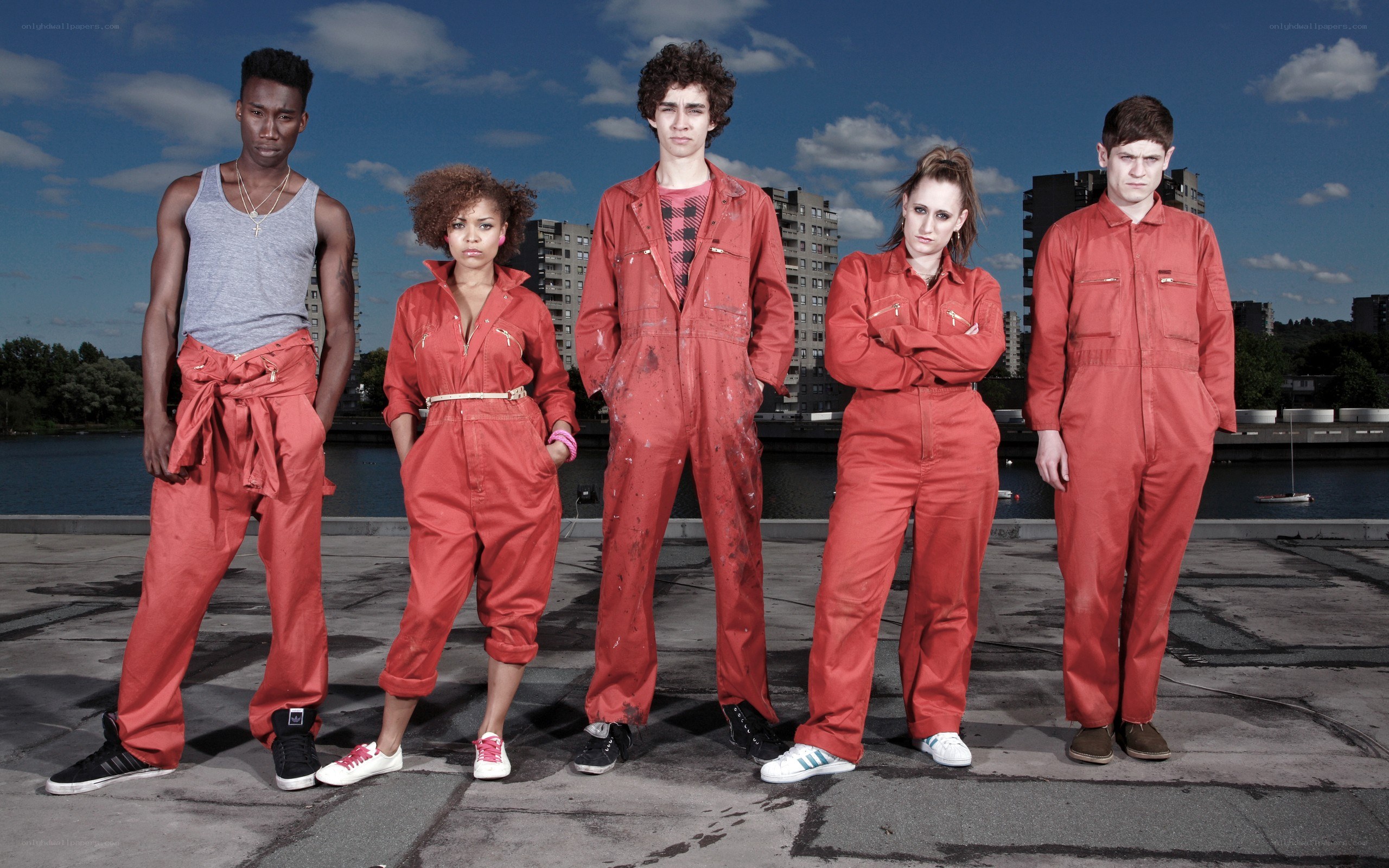 five people in red overalls