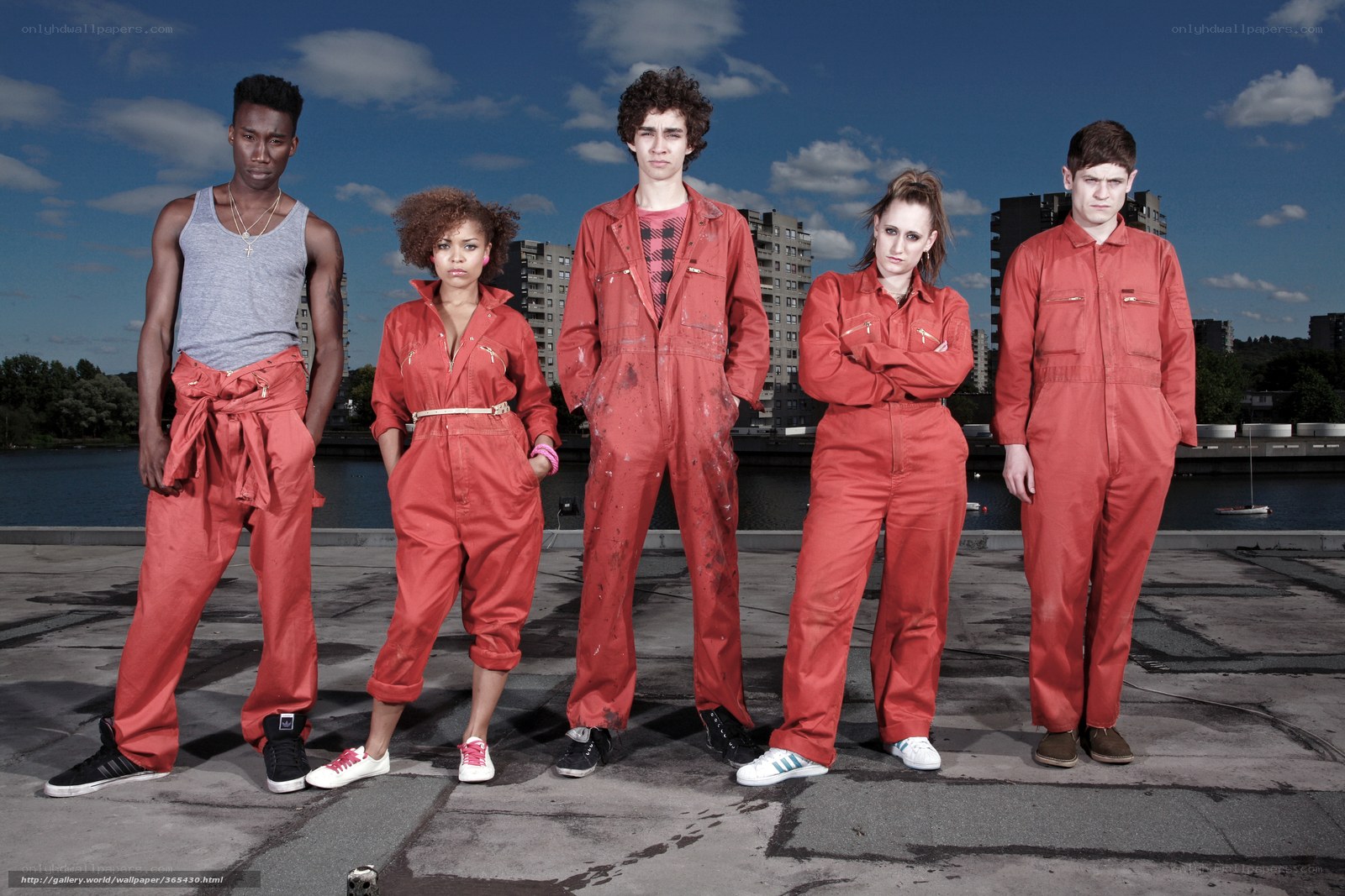 Five people in red overalls