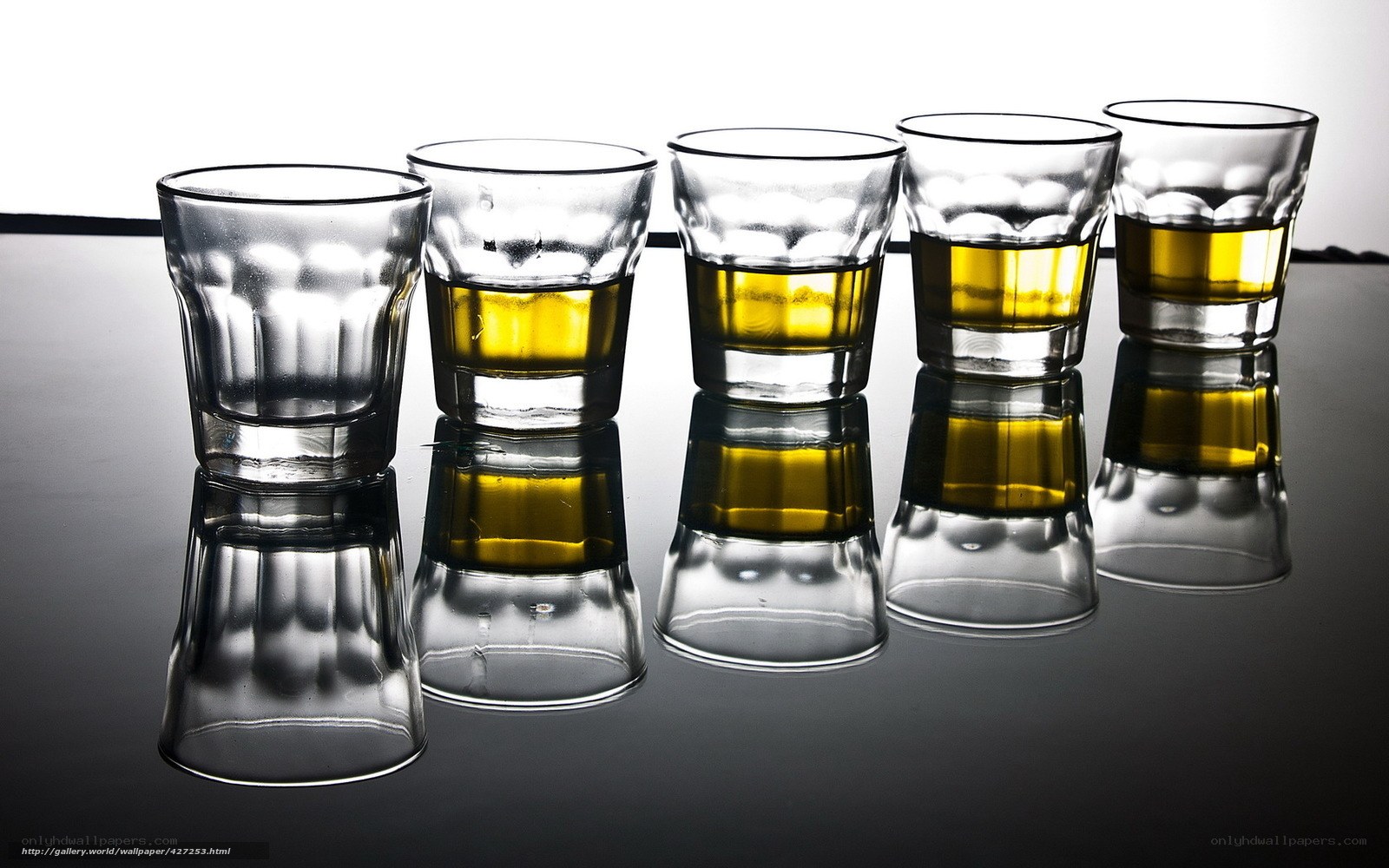 Five shot glasses with liquid