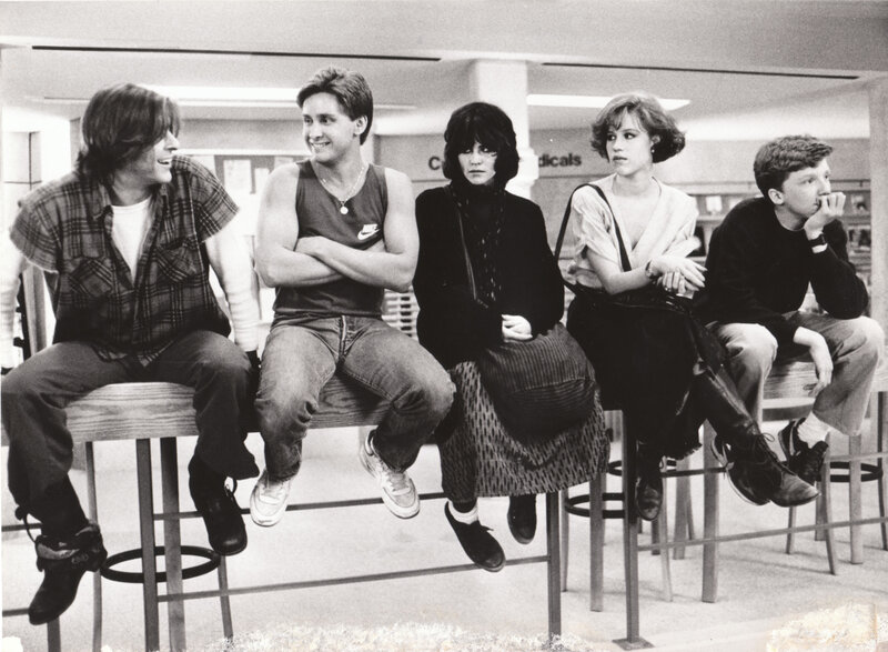 Five teenagers sitting on stools