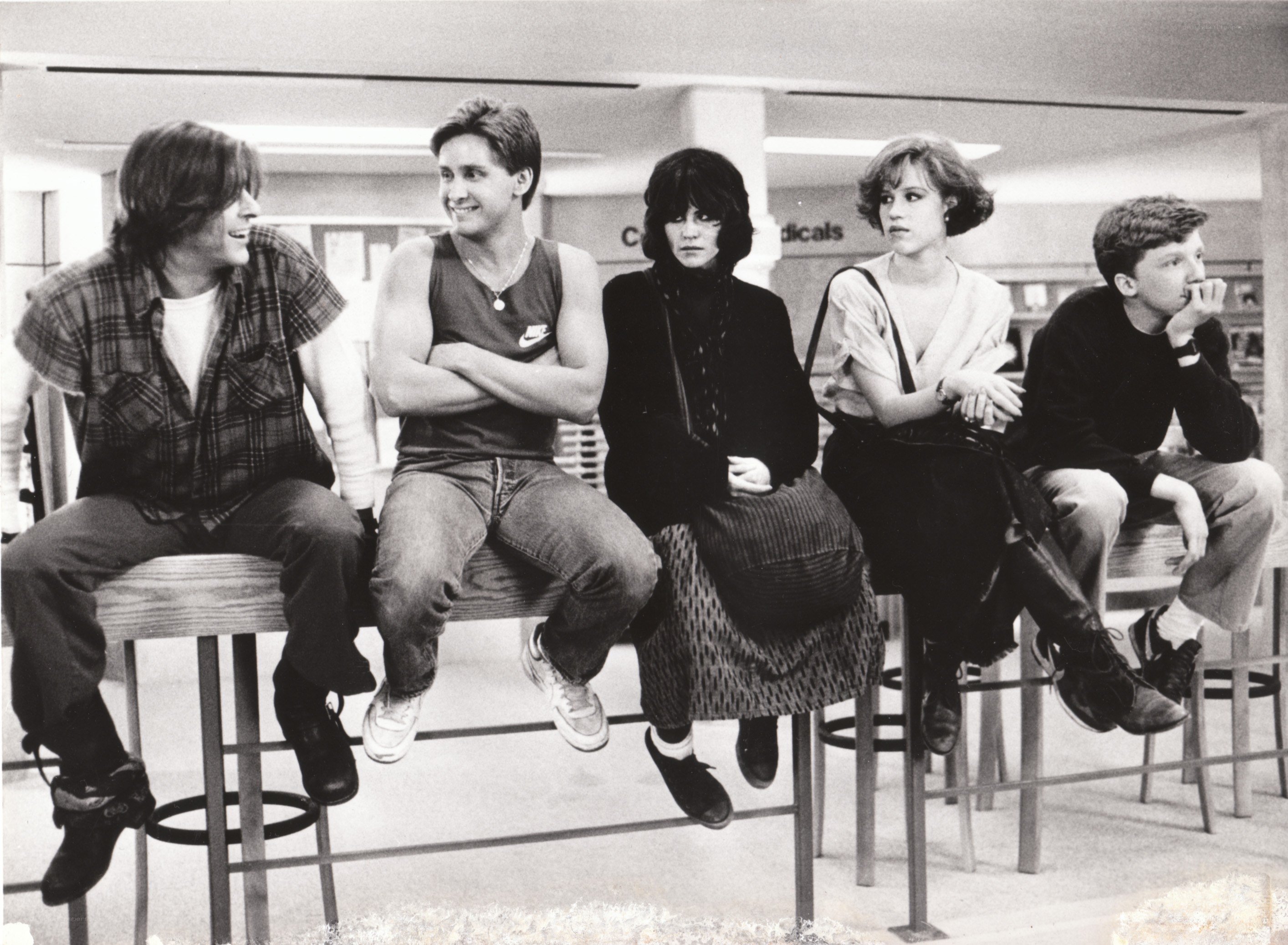 Five teenagers sitting on stools