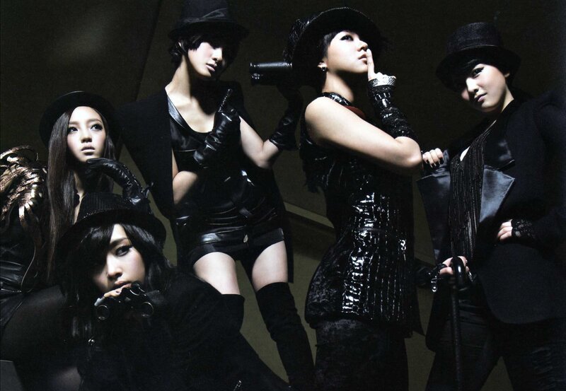 five women in black outfits