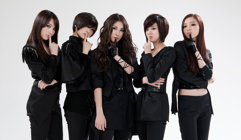 five women in black posing