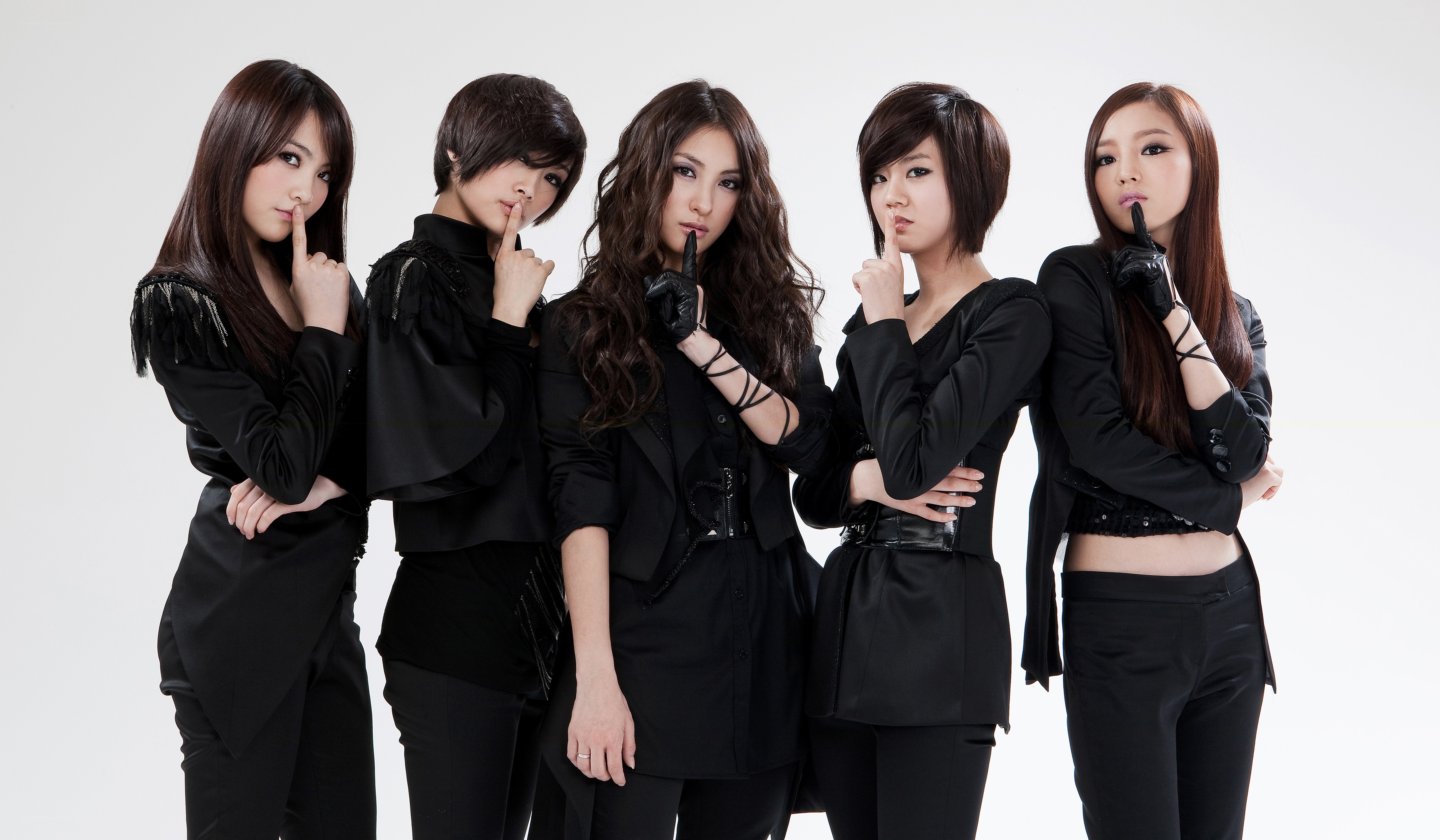 five women in black posing