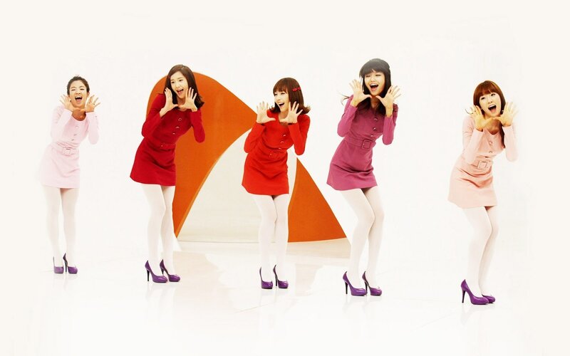 five women in colorful dresses