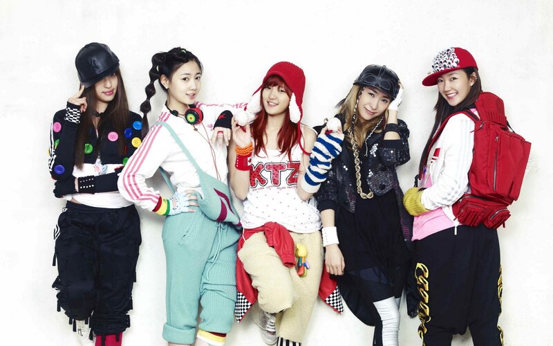 five women in colorful outfits