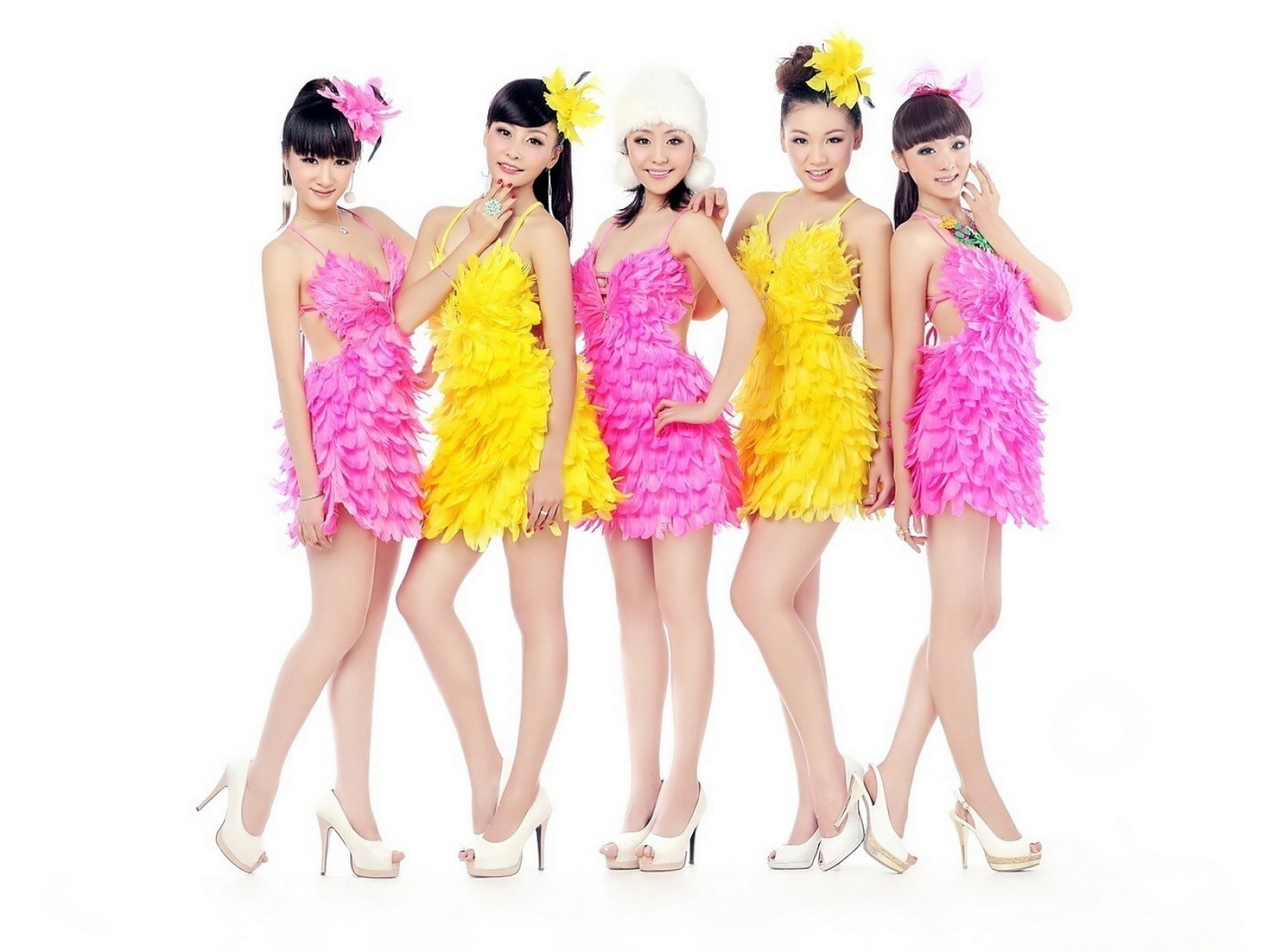 five women in feather dresses