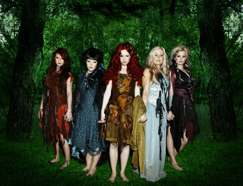five women in forest costumes