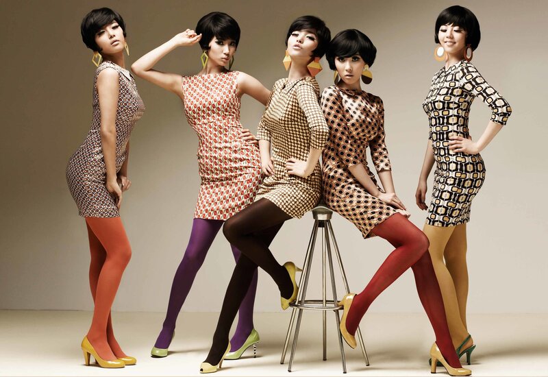 five women in patterned dresses