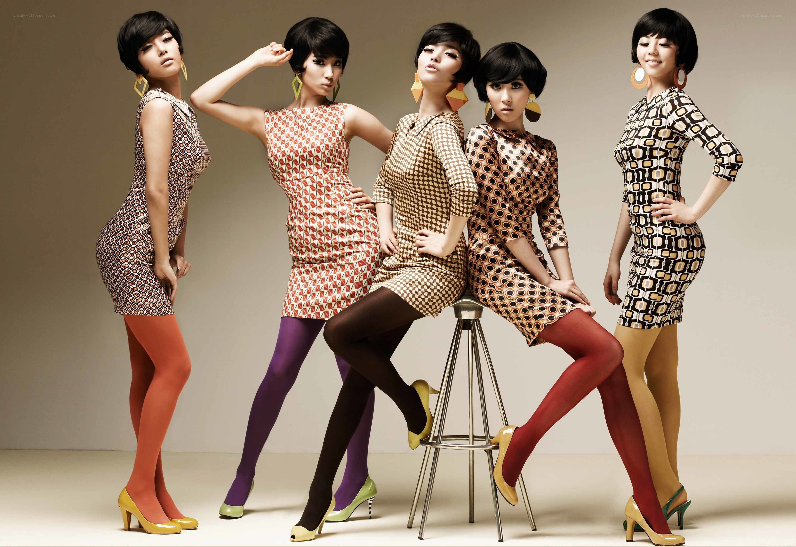 five women in patterned dresses