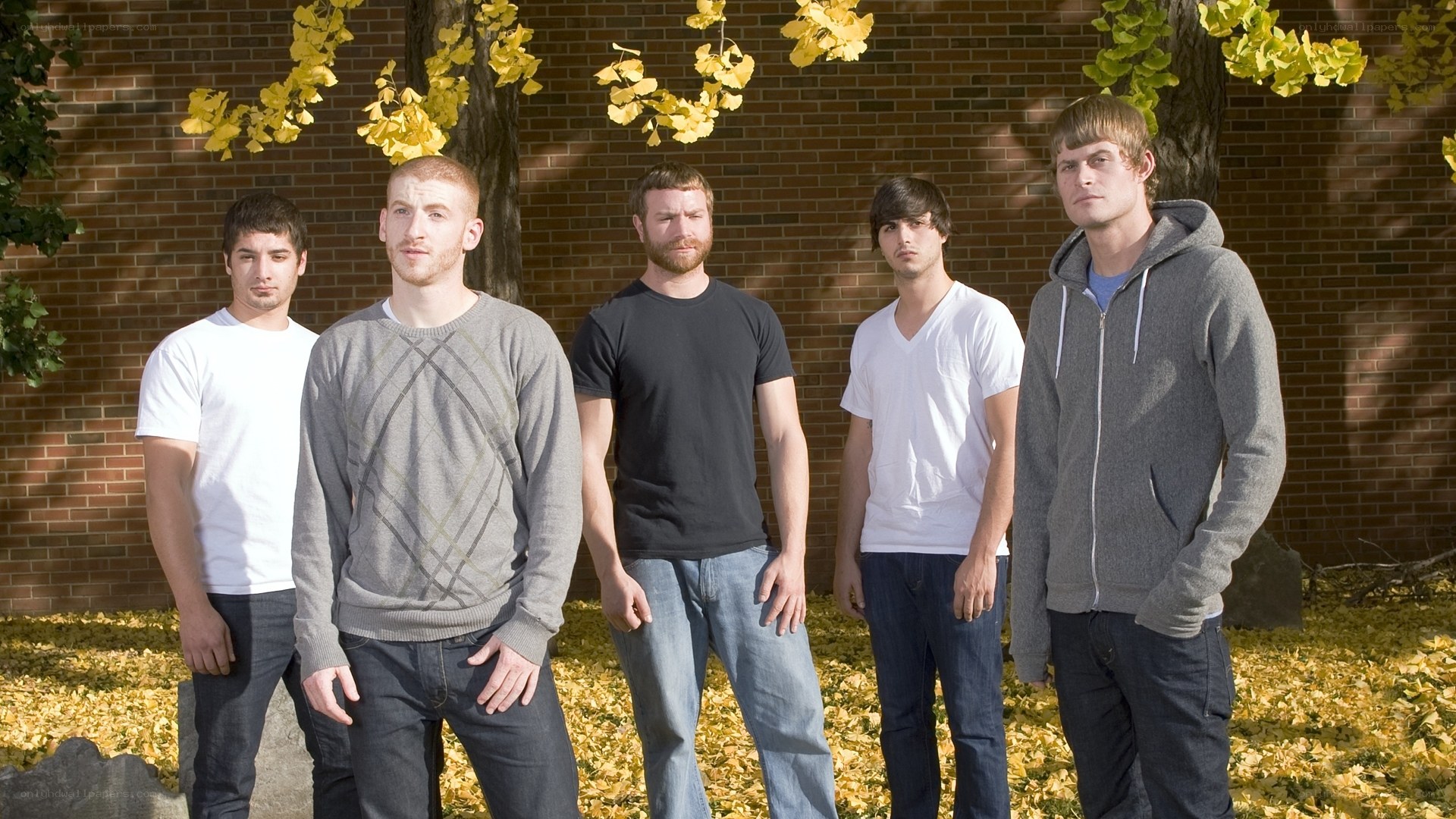 five young men standing outdoors