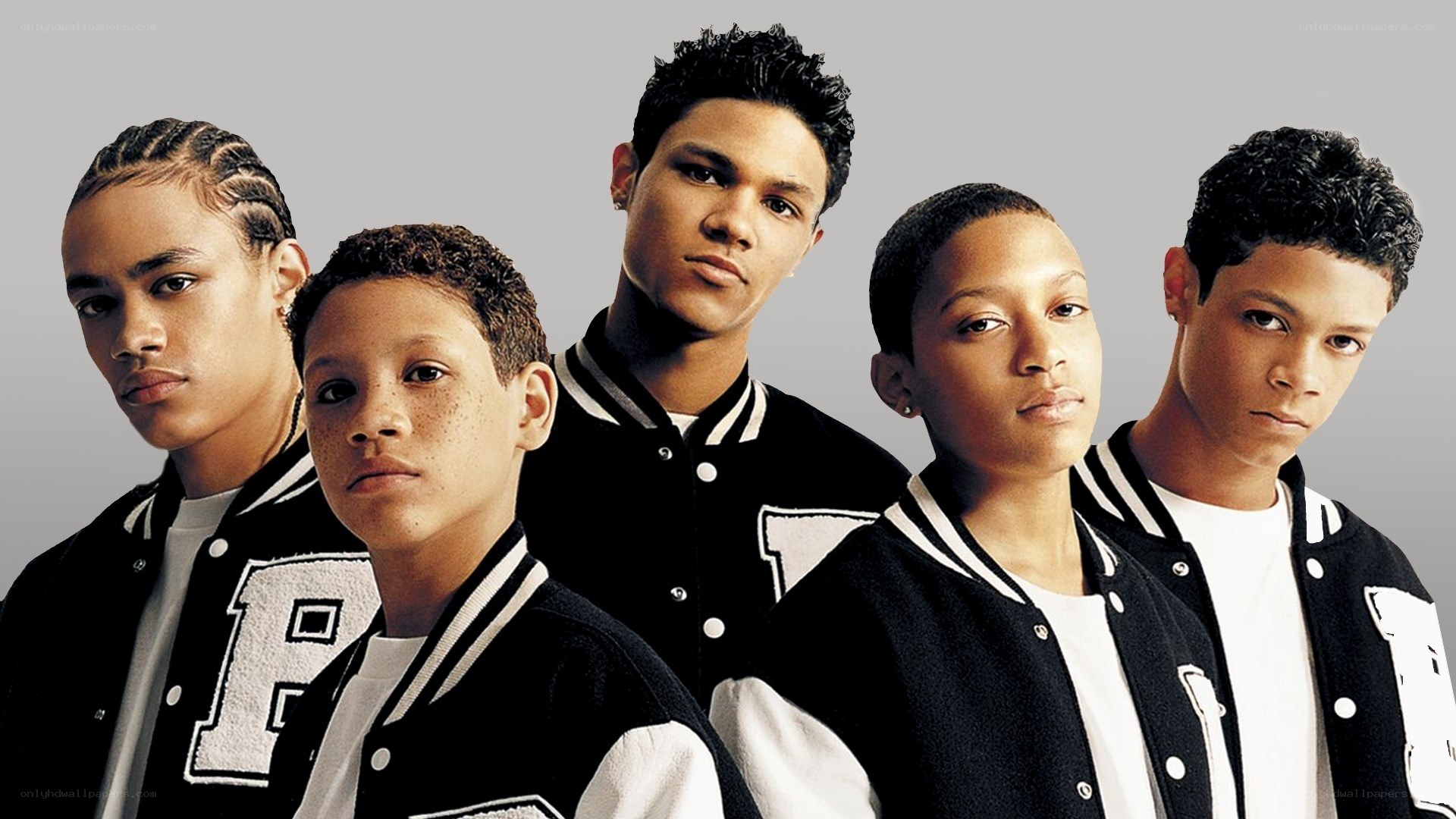 Five young people in letterman jackets
