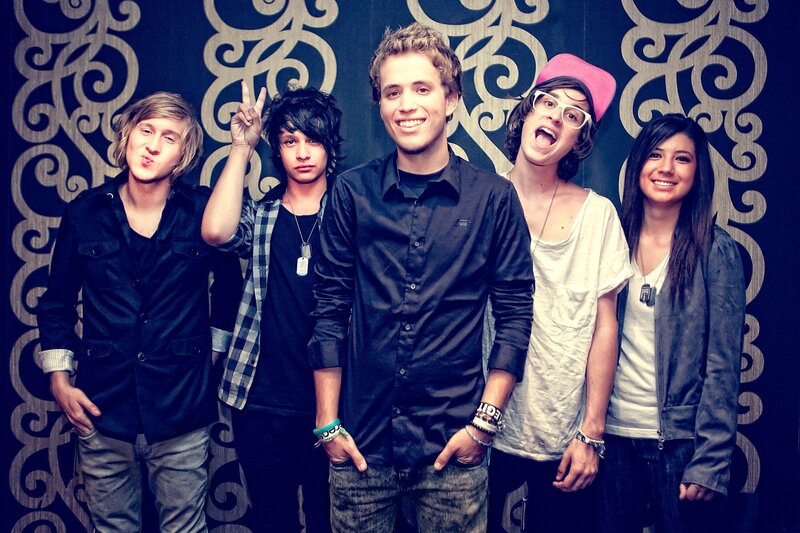 five young people posing together