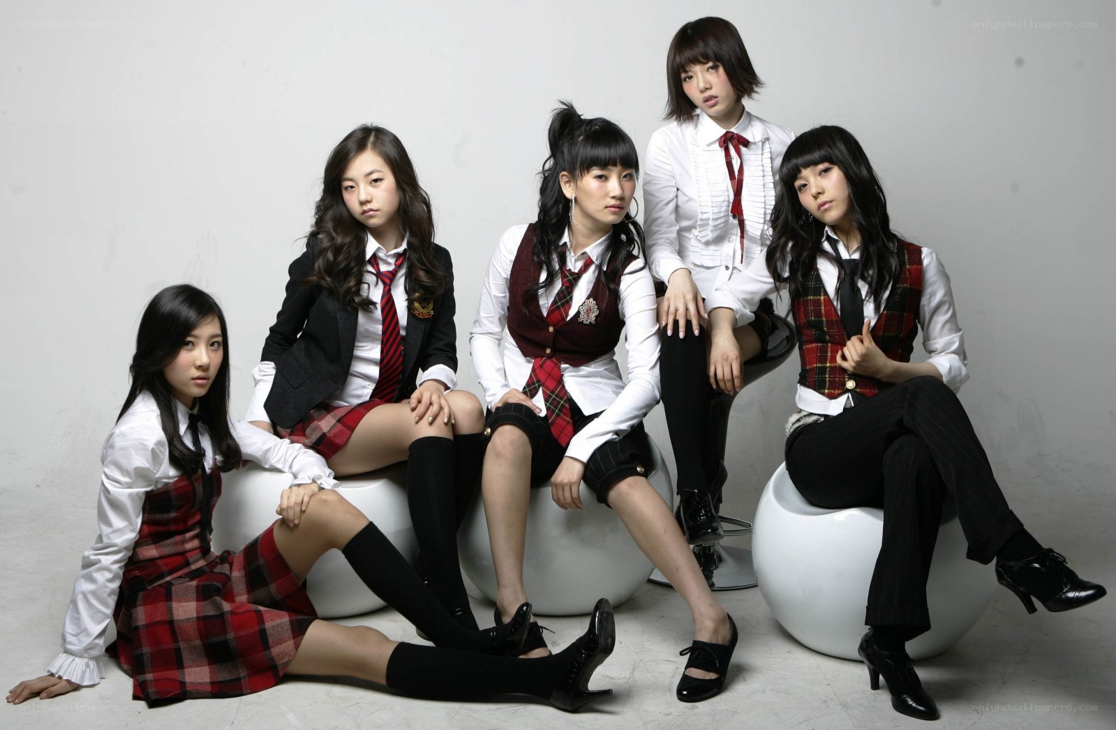 five young women in school uniforms