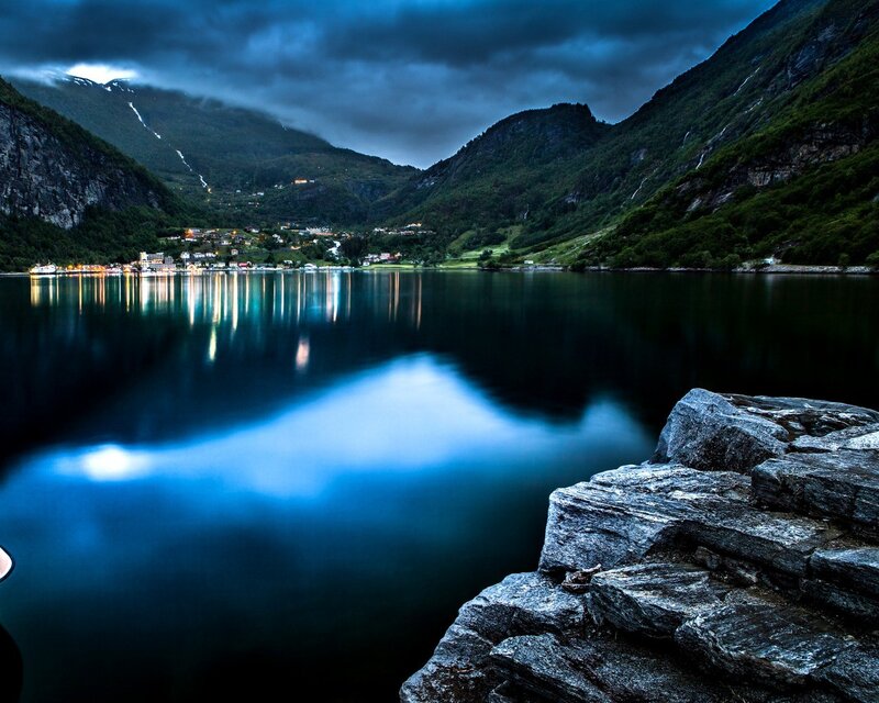Fjord at dusk with village lights
