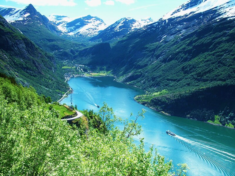 fjord with boats and mountains