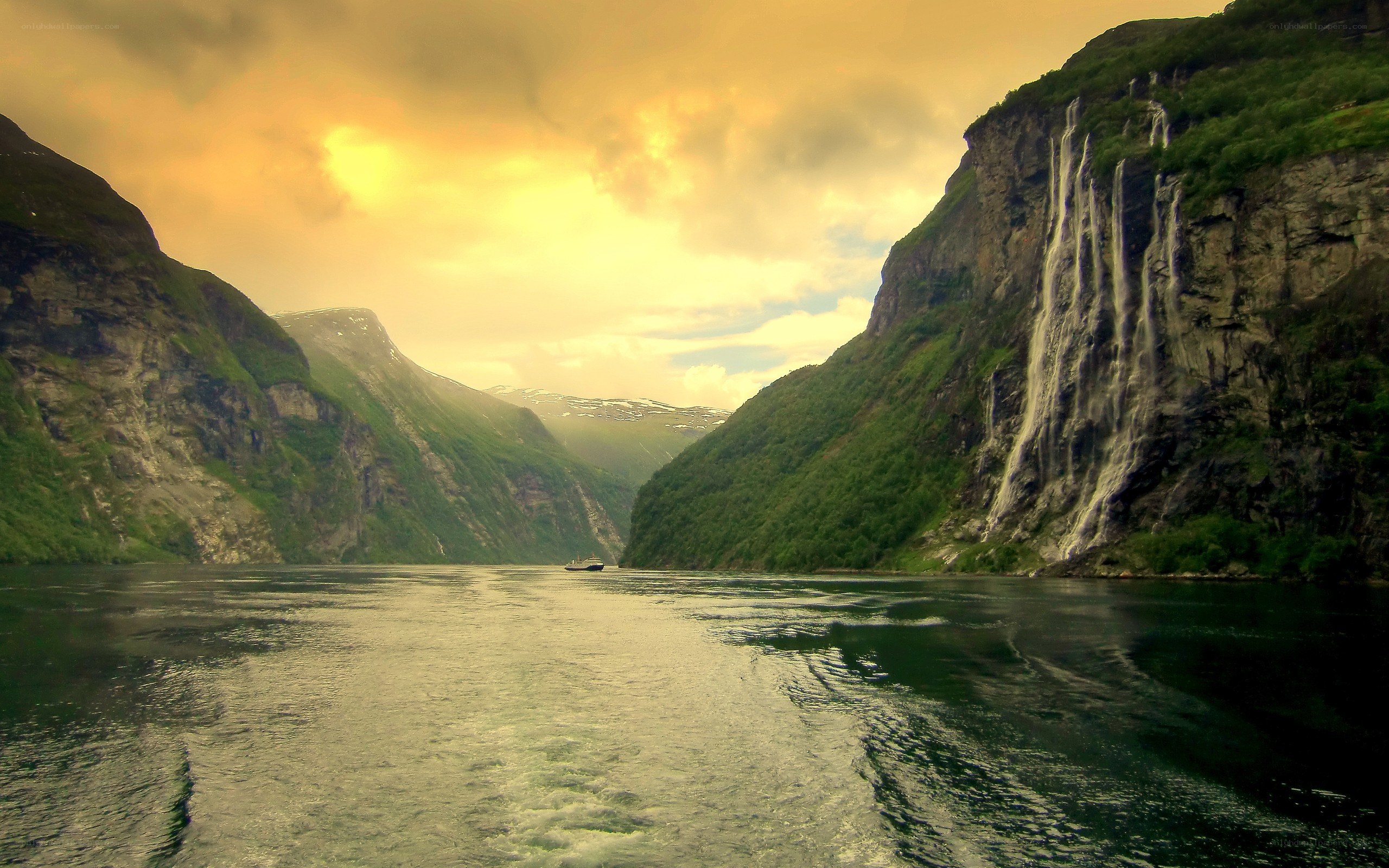 fjord with waterfall at sunset