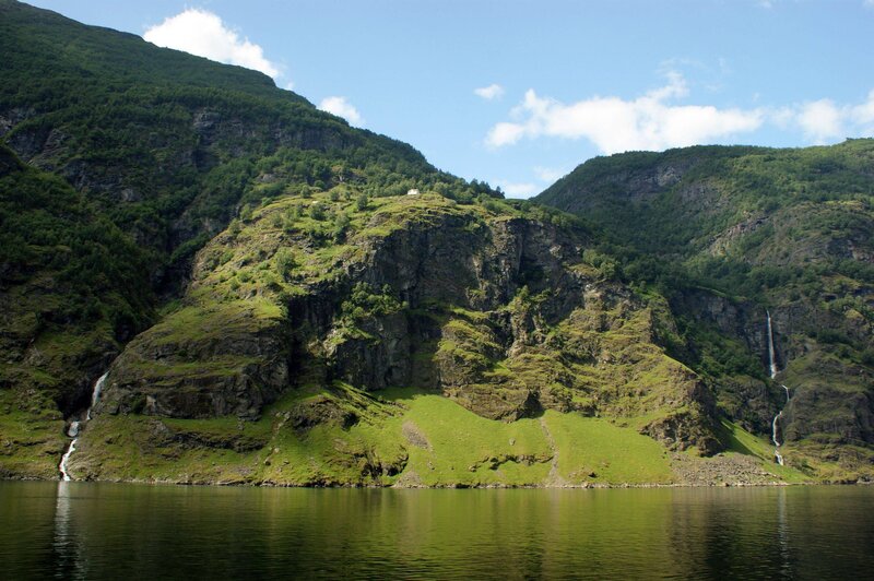 fjord with waterfalls and green hills