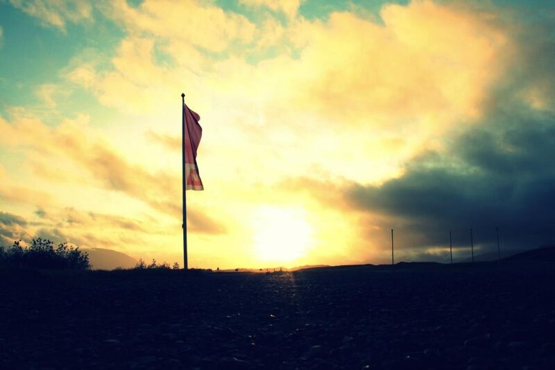 Flag at sunset on a hill