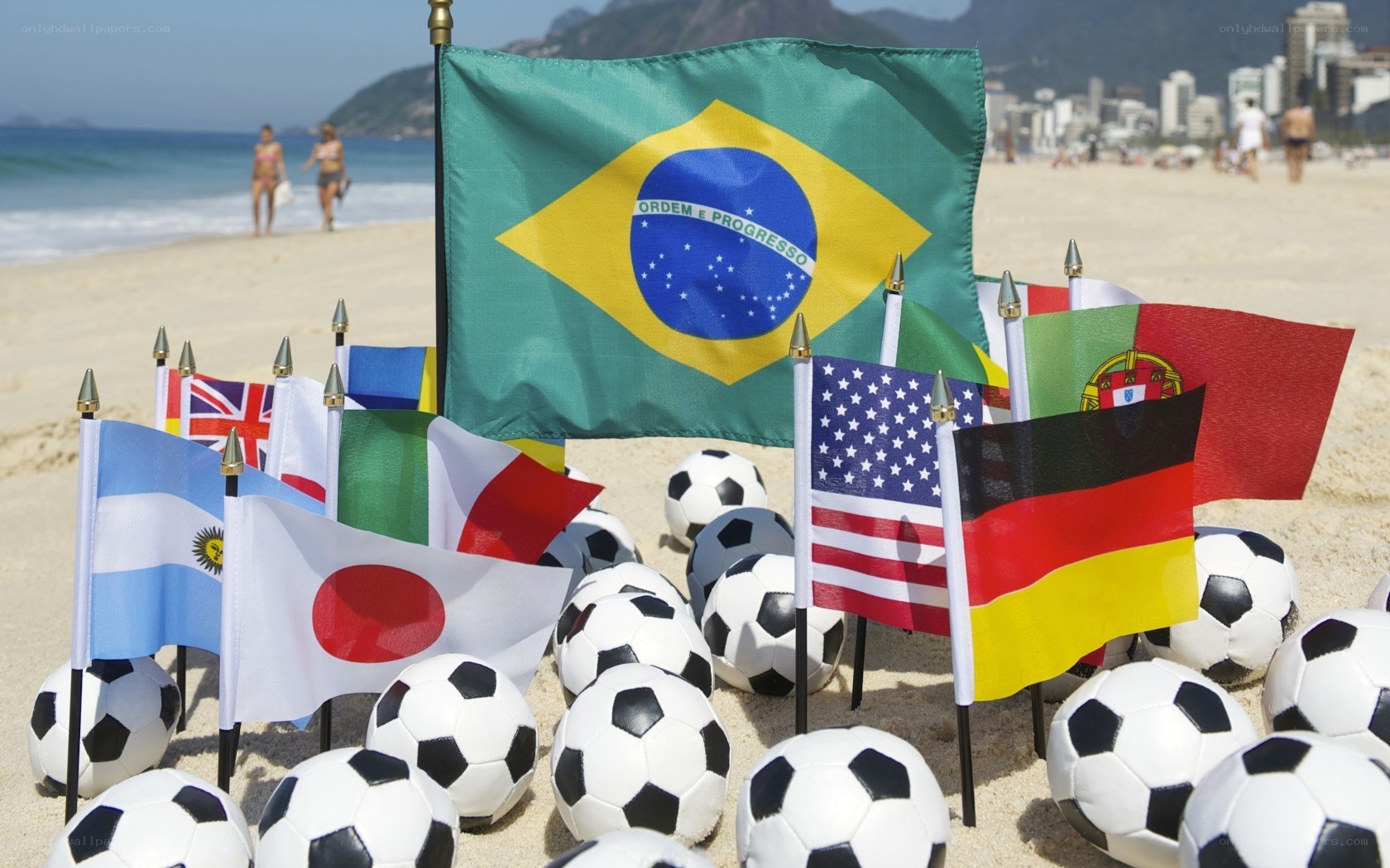 Flags and soccer balls on beach