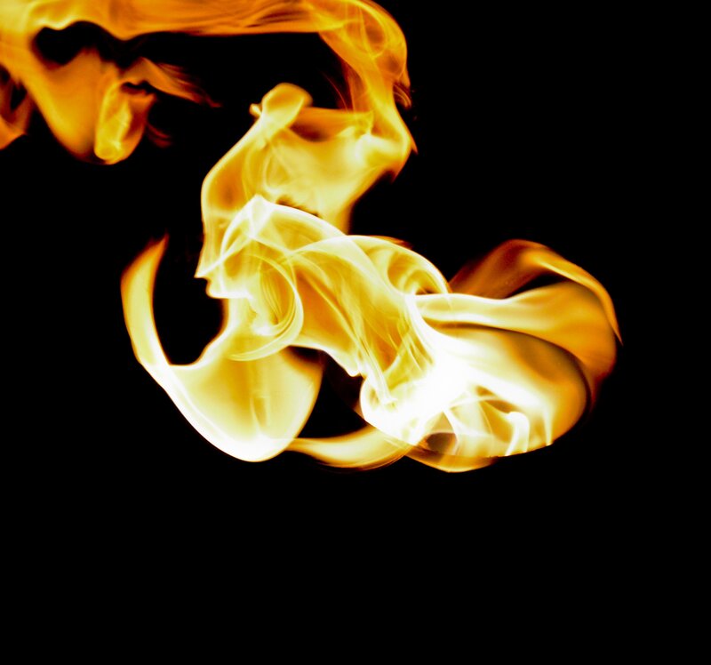 Flame Against Black Background — Yellow