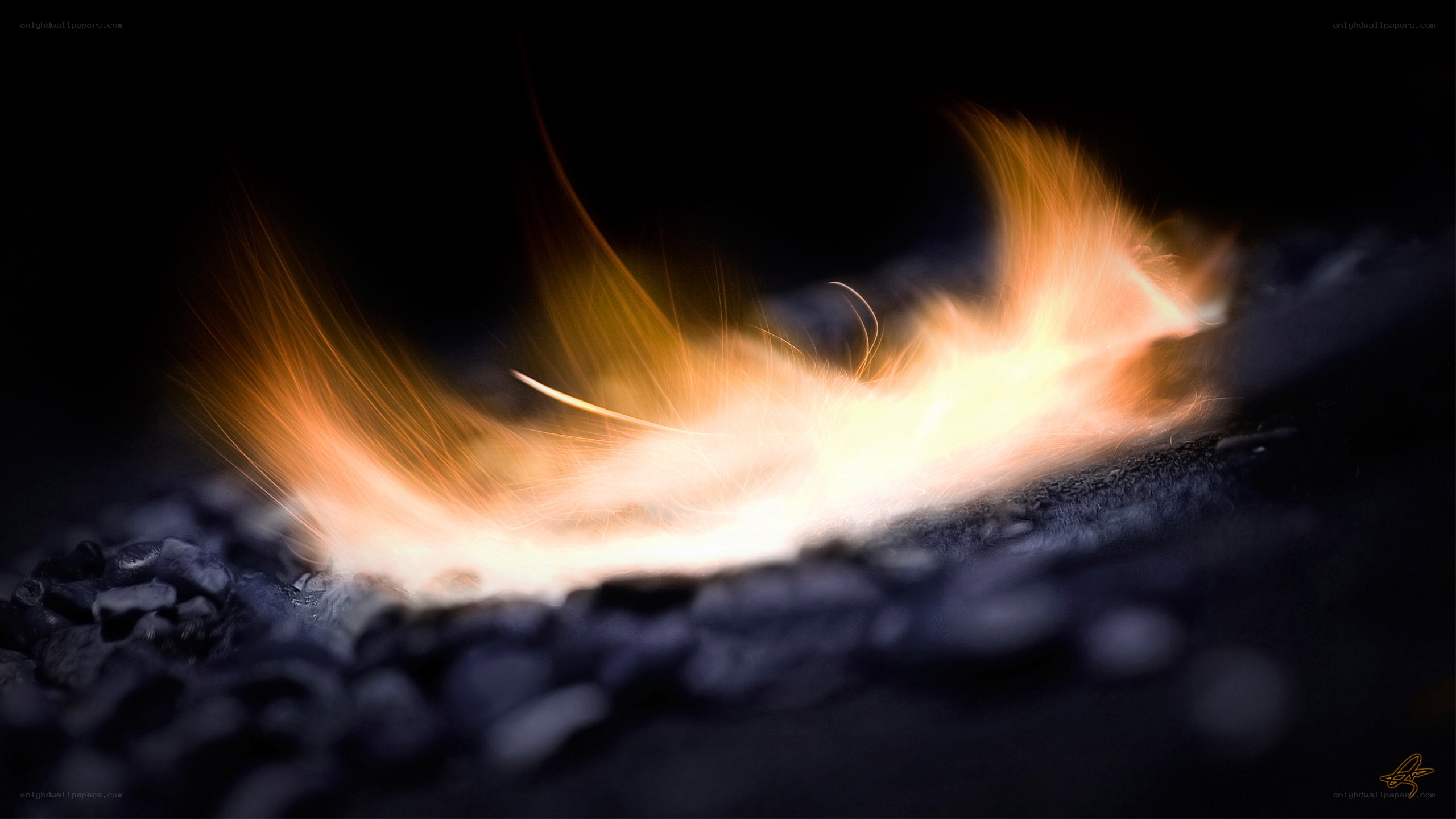 flame on dark gravel