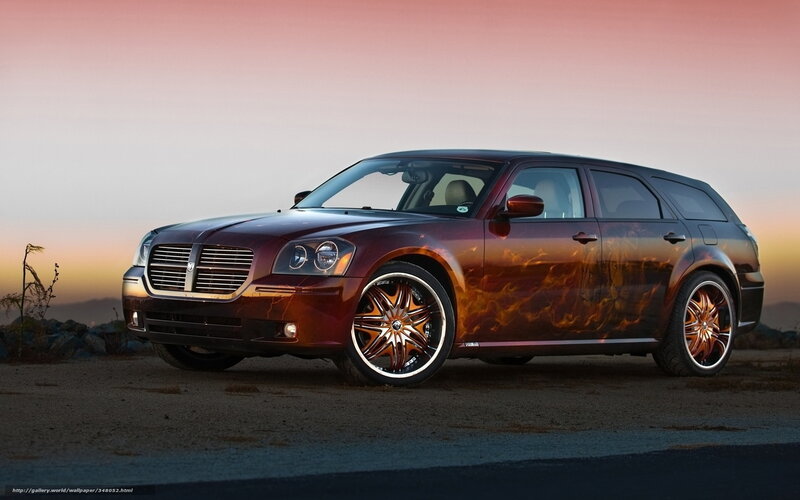 flame-painted car at sunset
